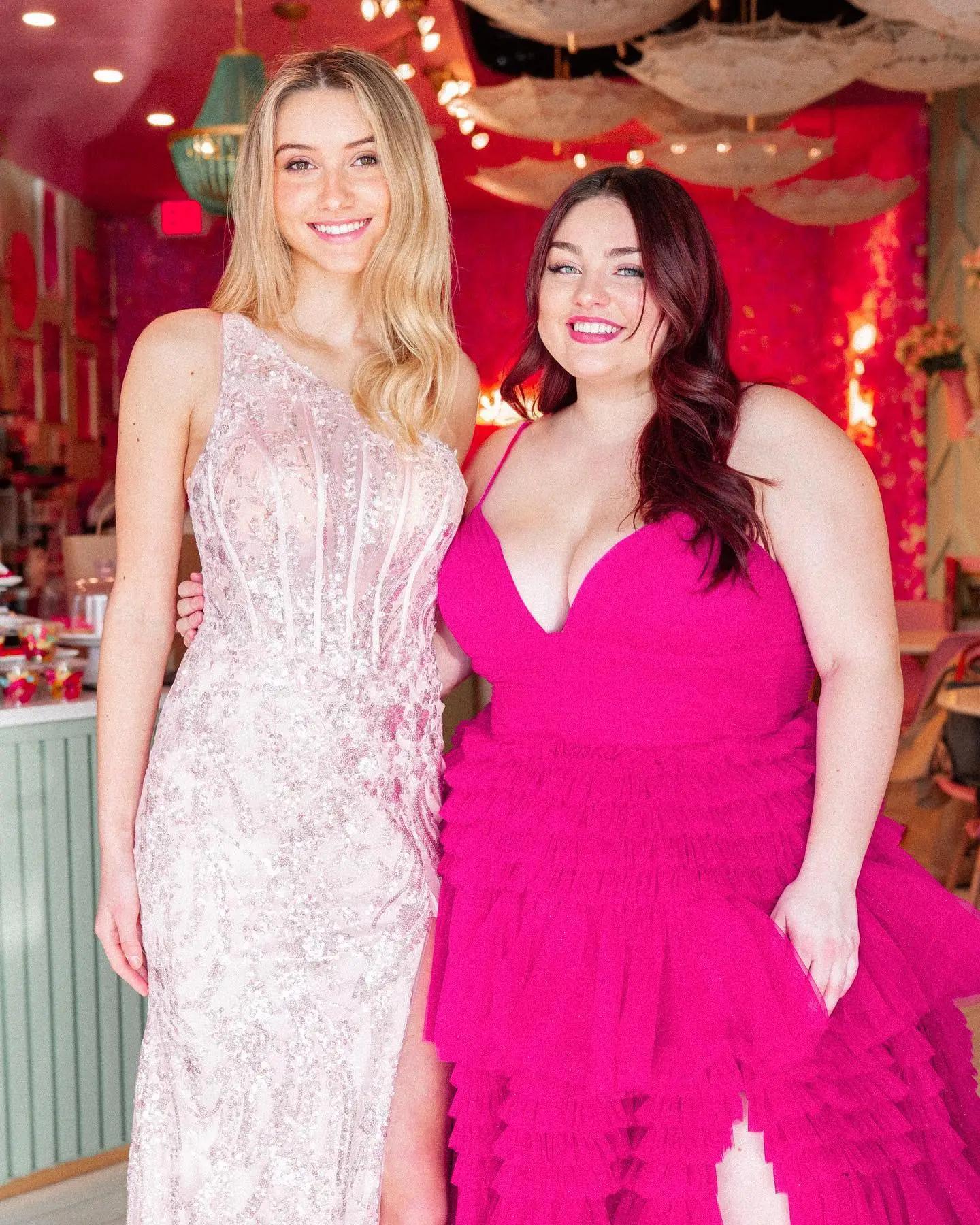 Two girls wearing pink prom dress
